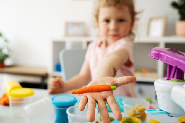 Front view blurry kid with playdough