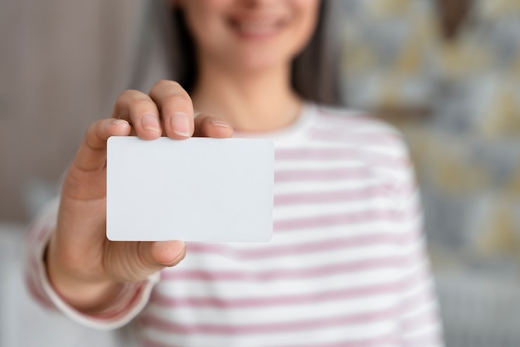 Free Photo front view blurry woman holding business card