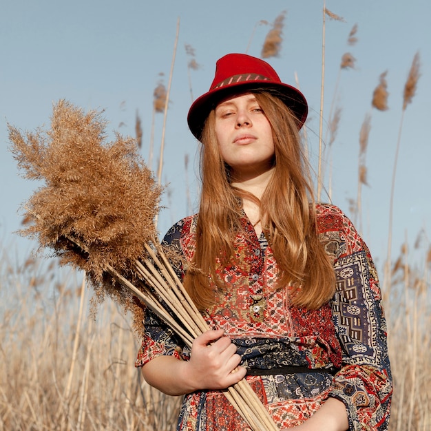 Front view of bohemian woman posing in nature