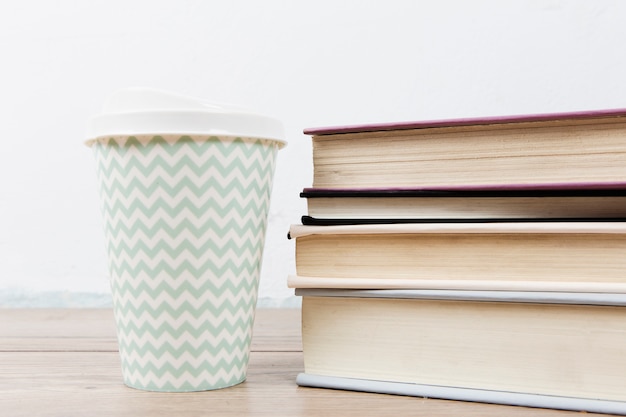 Front view of book arrangement and cup