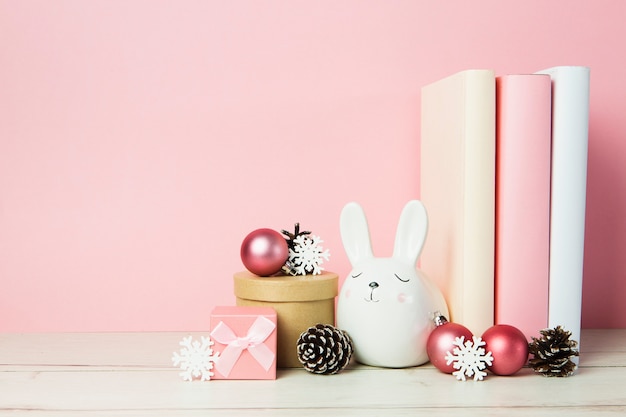 Front view of book arrangement with pink background