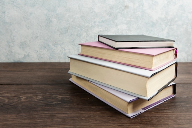 Front view of book arrangement  on wooden table