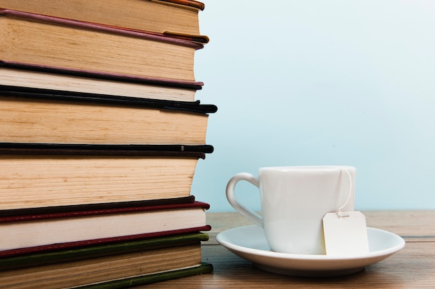 Free photo front view of books and tea mug with copy space