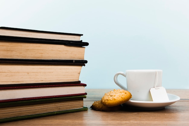 Free photo front view of books and tea mug