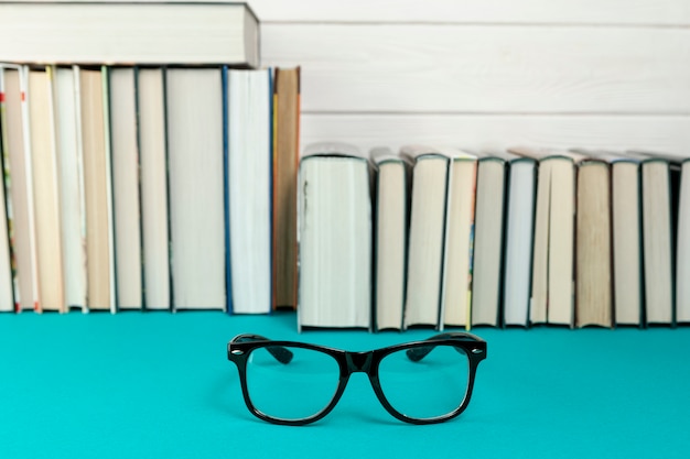 Front view books with glasses