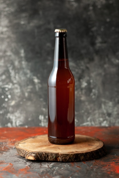 Front view bottle of bear on dark desk