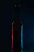 Free photo front view bottle of beer on dark blue background drink color water soda glass darkness photo