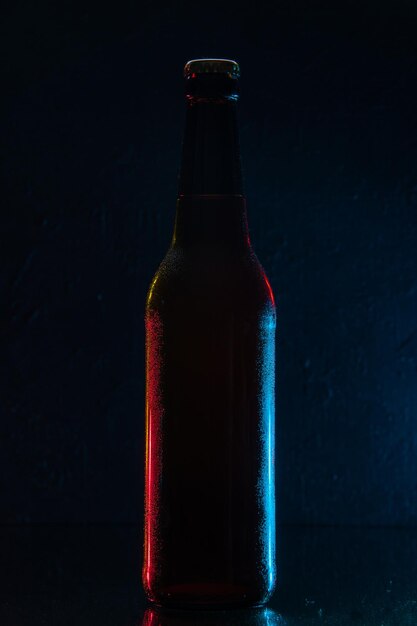 Front view bottle of beer on dark blue background drink color water soda glass darkness photo