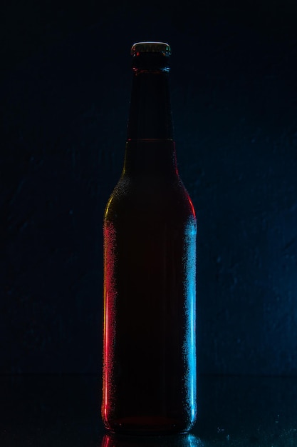 Front view bottle of beer on dark blue background drink color water soda glass darkness photo