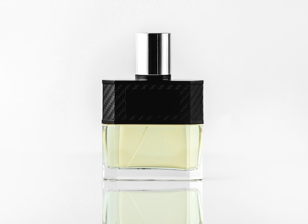 A front view bottle fragrance or parfume in designed colors on the white wall