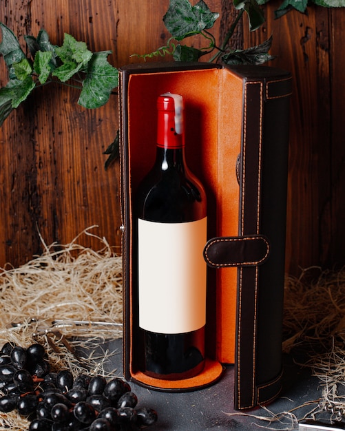 A front view bottle of wine red wine with burgundy cap inside box alcohol winery