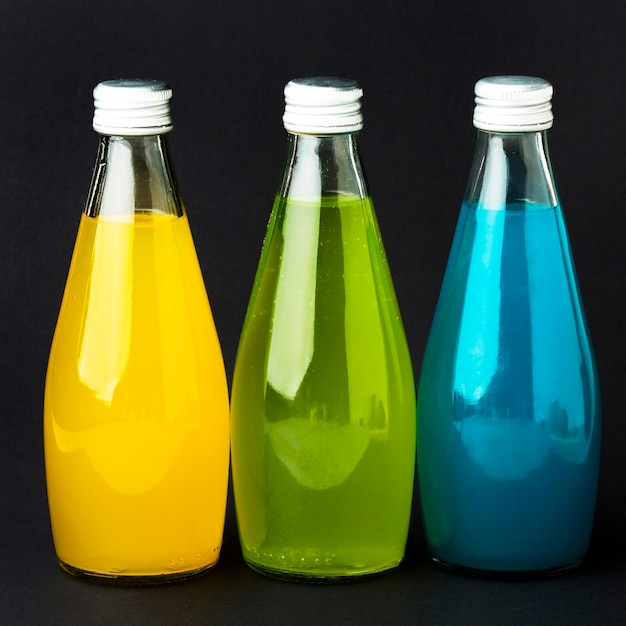 Free photo front view of bottles with soft drinks