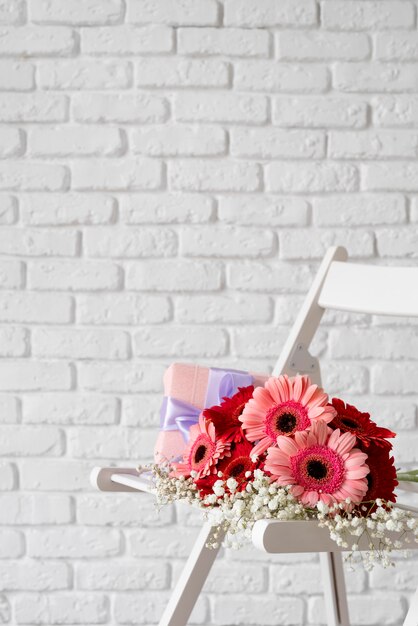 Front view of bouquet of flowers on white chair