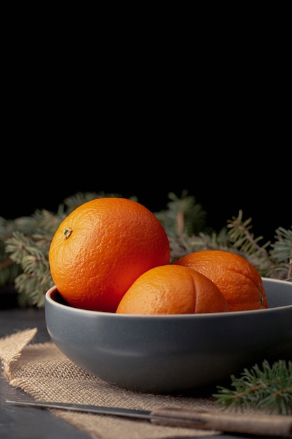 Front view of bowl with tangerines and copy space