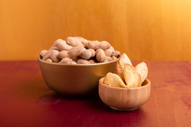 Front view of bowls of peanuts and fortune cookies for chinese new year