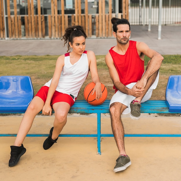Front view of boy and girl with basketball ball