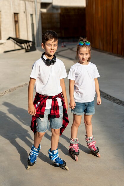 Front view of boy and girl with roller blades