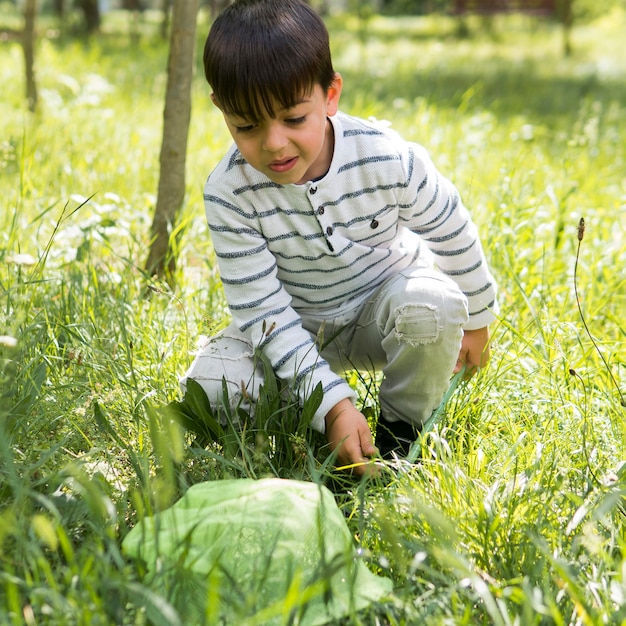 Front view boy in the grass