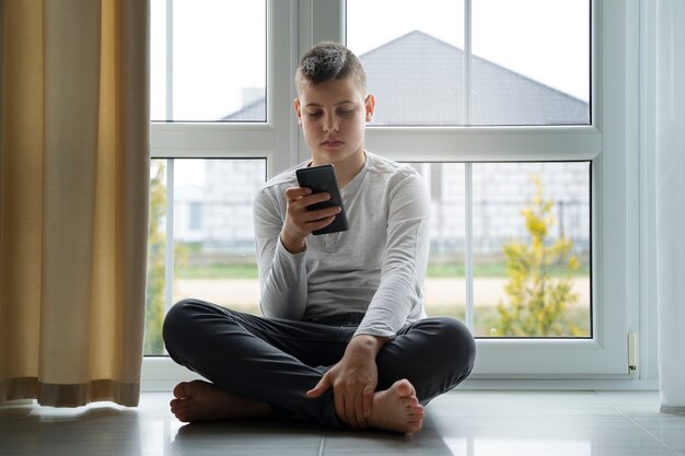 Front view boy holding smartphone