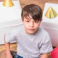 Free photo front view of a boy looking at camera