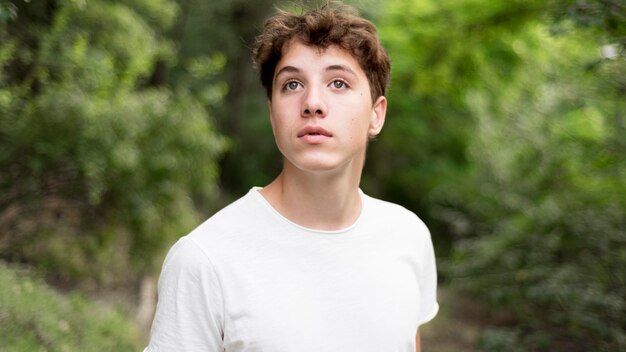 Front view of boy in nature