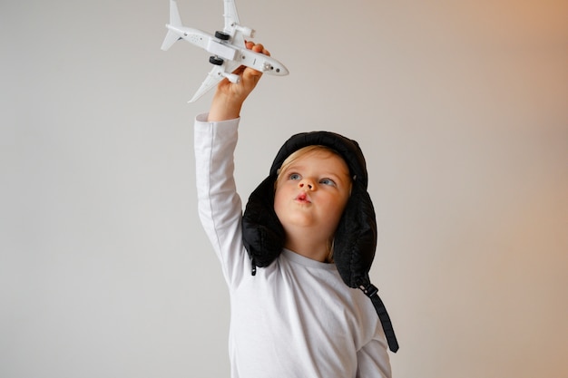 Free photo front view boy playing with airplane