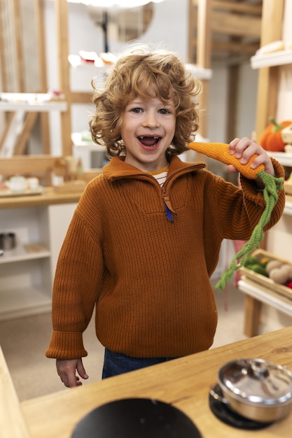 Free photo front view boy playing with ecological toys