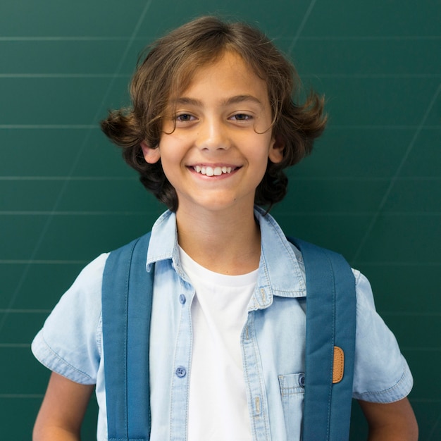 Free photo front view boy with backpack