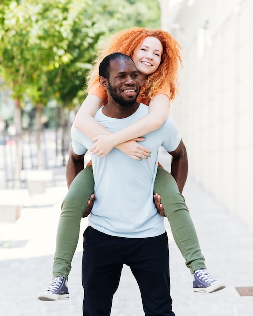 Front view of boyfriend carrying his girlfriend