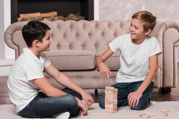 Free photo front view of boys playing a game on floor