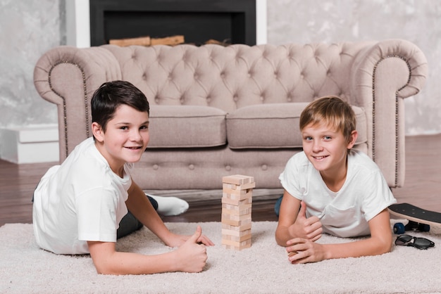 Free photo front view of boys playing a game on floor