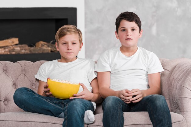 Front view of boys sitting on couch