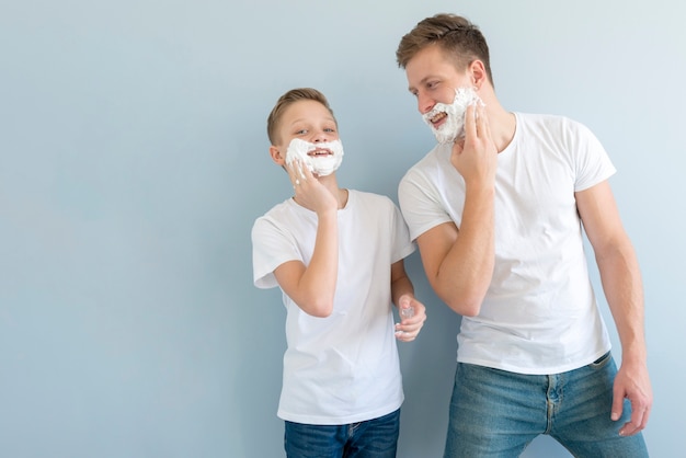 Free photo front view boys using shaving foam