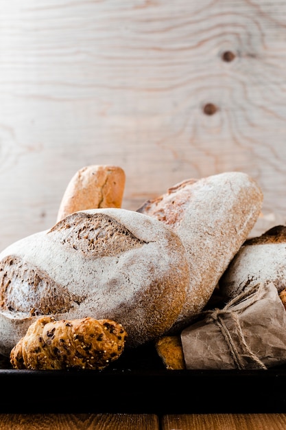 Front view of bread and croissant on a tray