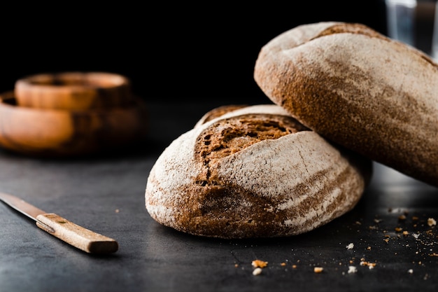 Front view of bread and knife on table