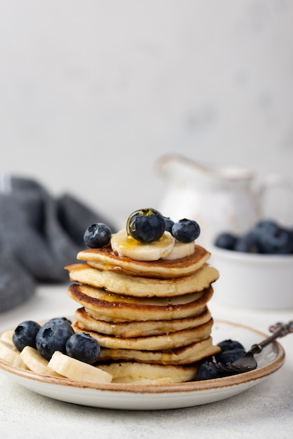 Front view of breakfast pancakes with blueberries and banana slices