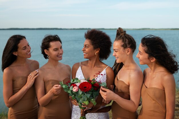 Front view bride and bridesmaids in nature