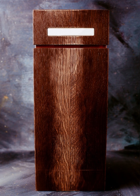 Front view brown casket on the bright wall