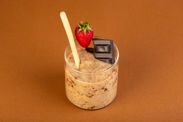 A front view brown choco dessert tasty delicious sweet with powdered coffee choco bar and strawberry isolated on the milk coffee background sweet freshing dessert