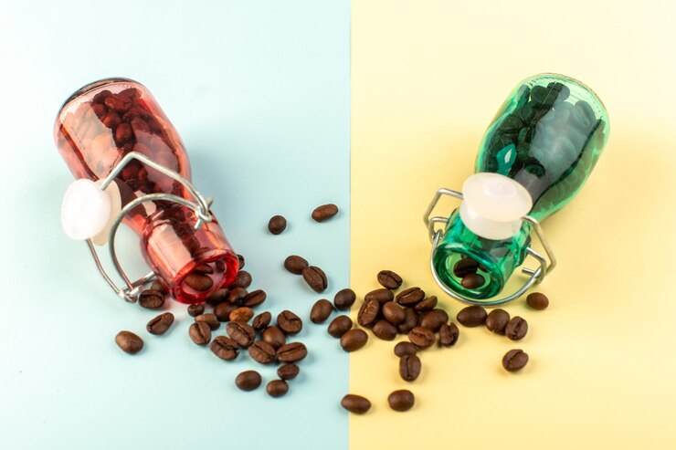 Free Photo a front view brown coffee seeds inside colored glass jars on the blue-yellow surface