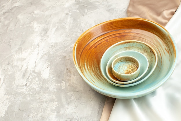 밝은 표면에 작은 접시가 있는 전면 보기 갈색 접시 주방 음식 여성 식사 수평 유리 색상 프리미엄 사진