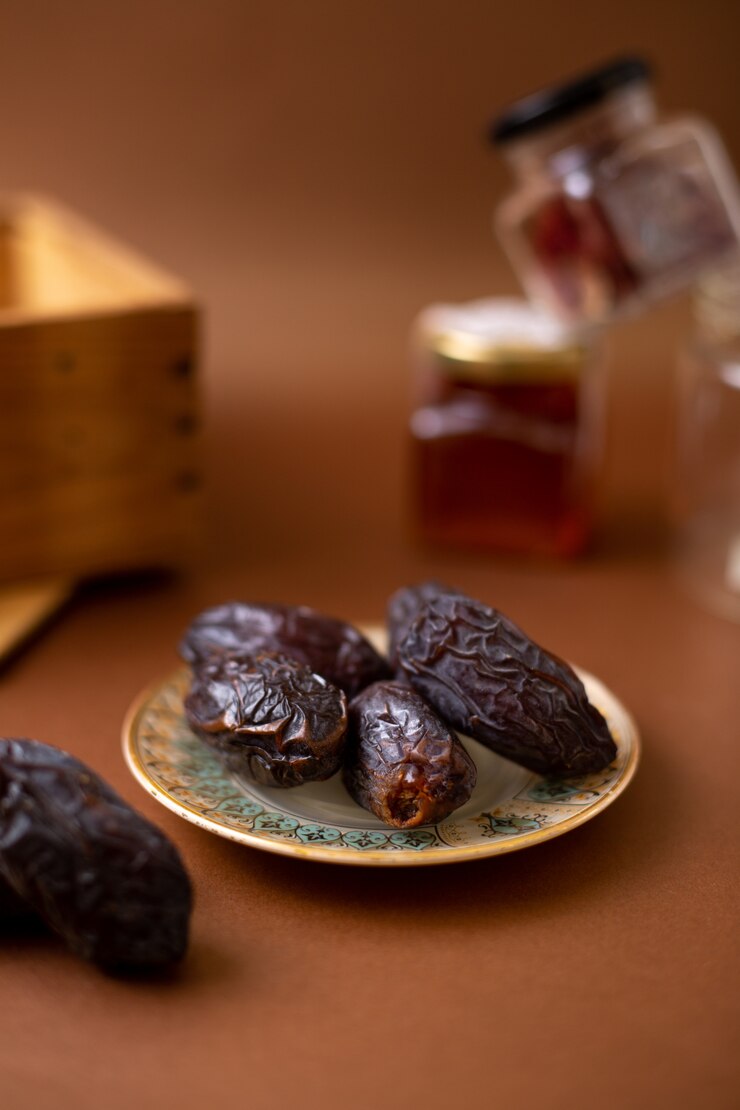 Free Photo front view brown tasty xurma inside plate on the wooden desk
