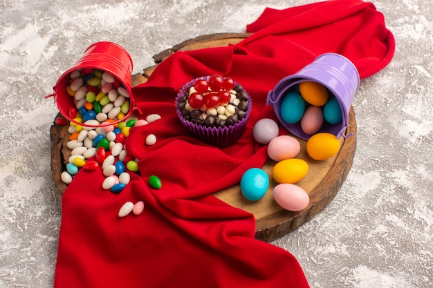 Front view of brownie and candies on the light desk