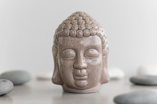 Free photo front view of buddha head statue