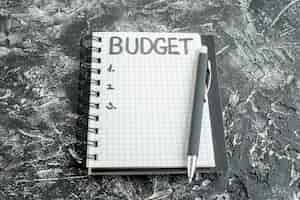 Free photo front view budget written note on notepad with pen on gray background