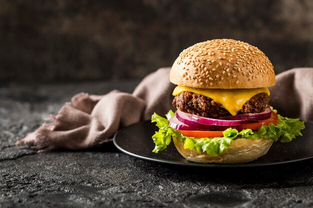 Front view burger on plate with kitchen towel