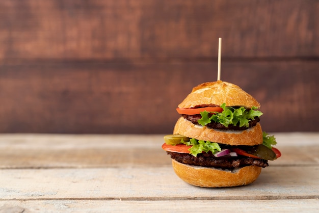 Front view burger with wooden background