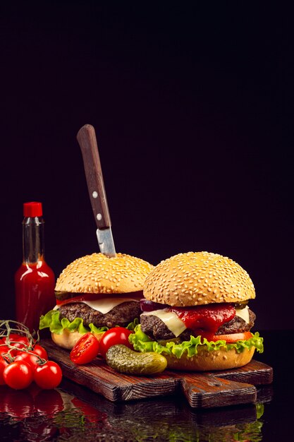 Front view burgers on cutting board