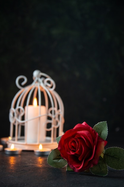 Front view of burning candle in lamp as memory for fallen on dark floor israel war death