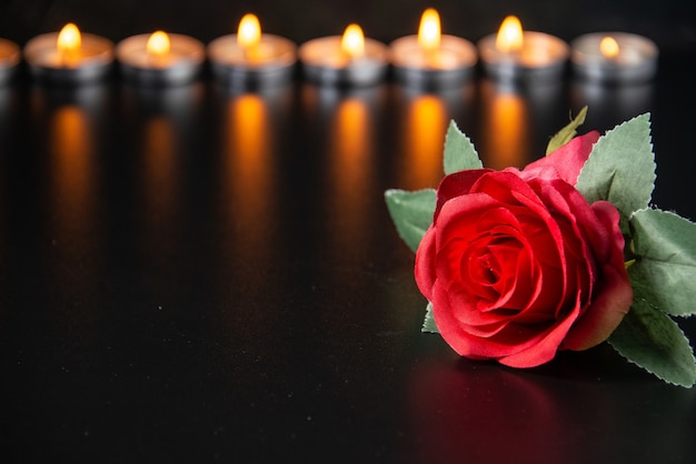 Free photo front view of burning candles as memory for fallen on a black surface